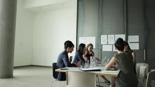 Businesswomen Meeting Around Table in Modern Workplace