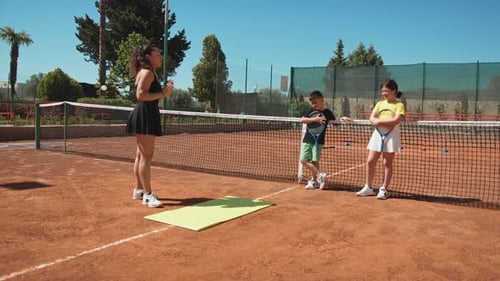 Teacher Female Explains Tennis On Outdoor Clay Court