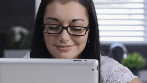 Woman using tablet device indoors