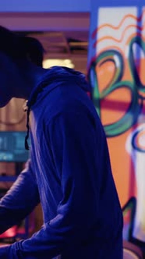 Young Coder Types at Computer in Graffiti Decorated Room