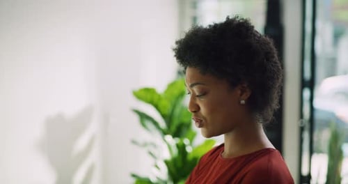 Stylish black woman tries on yellow sunglasses in toronto boutique