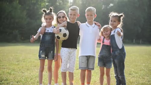 Group of Children Stand Together with a Soccer Ball