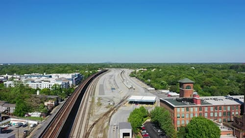 Industrial terminal for trains,trucks and overpass railroad beside factory in american town. Sunny d