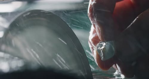 Slow motion close up of experienced goldsmith working on high quality aquamarine stones selected f