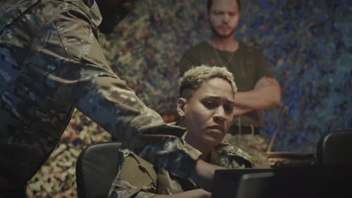 Diverse Military Workers Looking at Laptop in Cyber Security Office