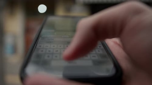 Close-up of the phone - man is texting in a messenger
