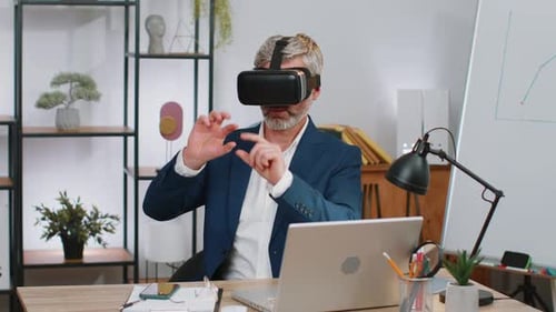 Mature Business Man in VR Goggles Watch Virtual Reality Video Working on Simulation Game at Office