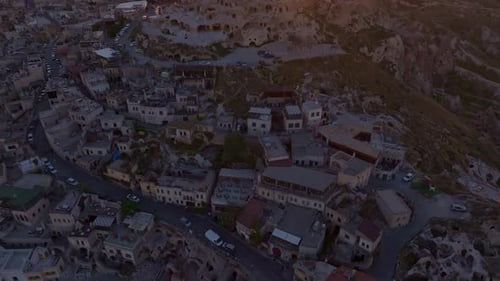 Aerial view of uchisar castle and rock formations at sunset, uchisar, turkey.