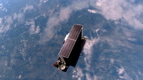 Satellite Deploying Solar Panels in Orbit Around Earth