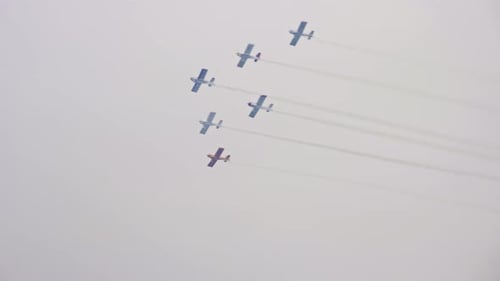 Aerobatic Airplanes Flying in Formation Leaving Smoke Trails