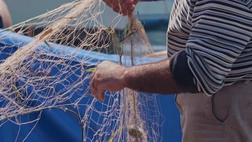 Fisherman Cleans Their Nets And Prepares New Fish