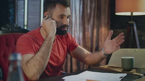 Emotional Man Talking Phone in Office at Evening. Business Mobile Conversation. Emotional