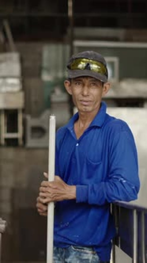 Adult Asian Man Holding a Light Tube and Looking Serious to the Camera FHD Vertical Video