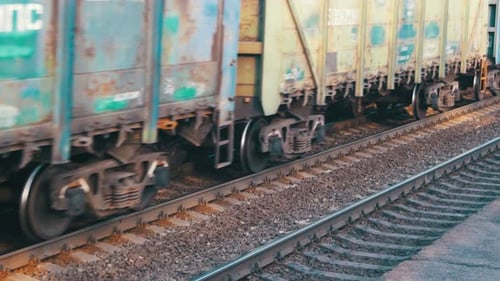 Cargo Train Passing by on Railroad Tracks