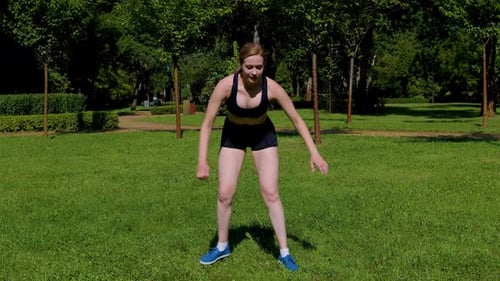 Lovely Athletic Fit Middle Aged Woman Practicing Skater Lunges Exercise in Park