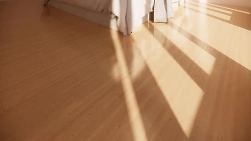 Bed in empty room with sunlight