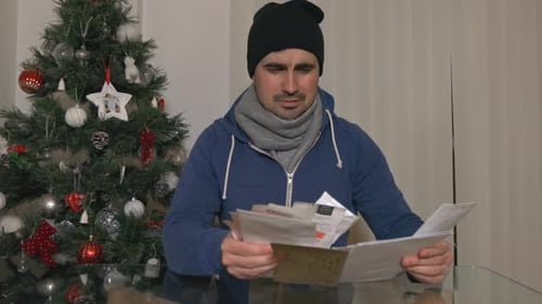 Distressed Man with Bills During the Christmas Season