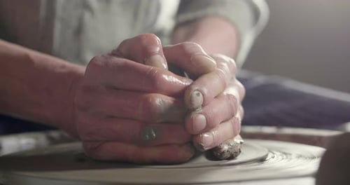 Hands Forming Clay on Pottery Wheel Close Up