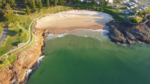 Waves On Sandy Shore Of Horseshoe Bay Beach During Golden Hour - Point Briner Peninsula At South Wes
