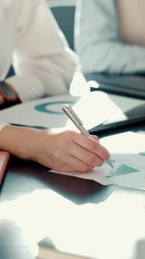 Hands, person and writing on graph document for financial planning, budget and profit stats