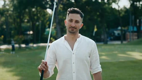 Portrait of Man Golfer Putting Driver Onto Shoulder on Field