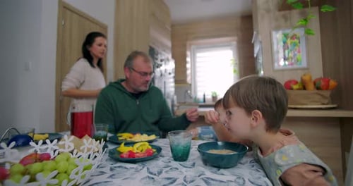 Family Eating Breakfast at the Table Together at Home