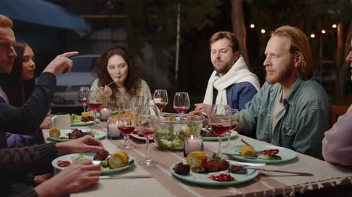 Friends Share Meal at Outdoor Dinner Party
