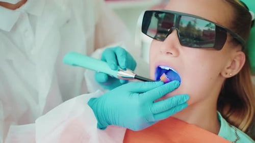 Dental Restoration in Modern Stomatological Clinic for Children Dentist Using Blue Lamp