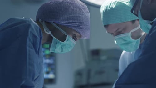 Focused Surgeons Performing Critical Procedure in Operating Room