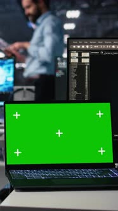 Vertical Video Data Center Engineer Working on Neural Network on Chroma Key Laptop