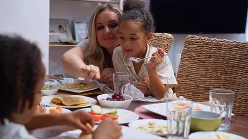 Family Meal Together at Home Around Dining Table