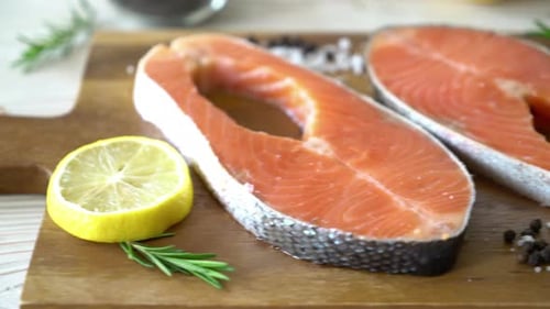 Salmon Steaks with Lemon and Rosemary on Board