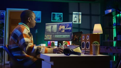 Young Adult Working at Desk Editing Video