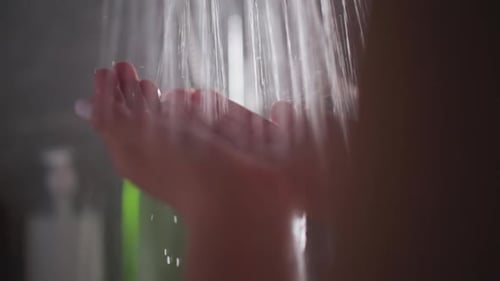 Woman Finds Solace in Gentle Cascade of Hot Water