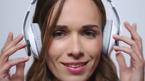 Woman listening to music on headphones close up