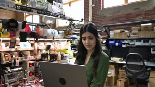 Dedicated Female Engineer Using Laptop in Semiconductor Factory Black Hair