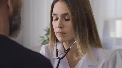 Female Doctor Checks Patient with Stethoscope