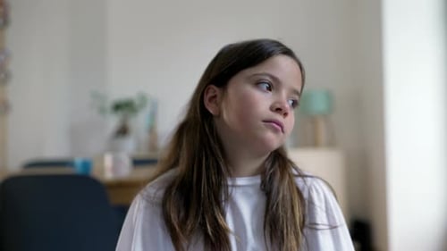 Pensive Girl Looks Away, Sad Indoors in a White Shirt