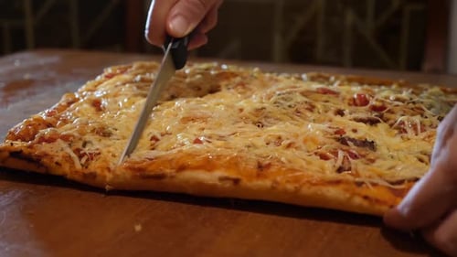 36x. Cutting ready-made fragrant pizza cooked at home.