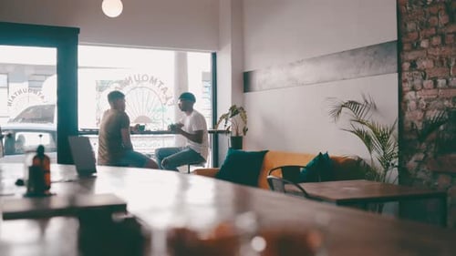 Friends, talking and men in coffee shop for conversation, discussion and bonding together