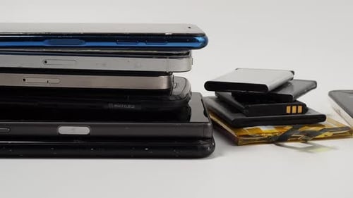 Stacks of Old Smartphones and Lithium Batteries