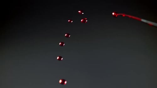 Drops of Blood From a Syringe Needle Filmed on a Highspeed Camera at 1000 Fps