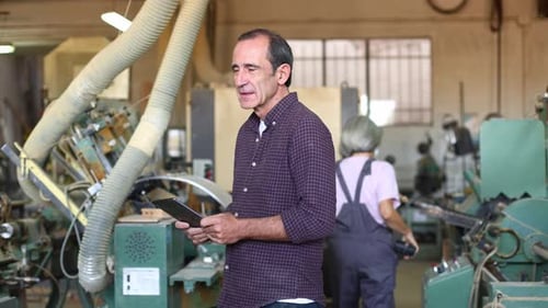 Supervisor Training Carpentry Apprentices in Woodworking Factory