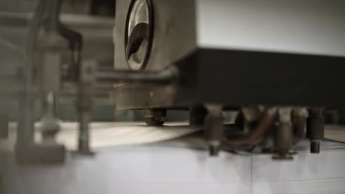 Close up of the printing machine where machine is separating and lifting sheets of paper and sending