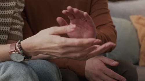 Affectionate Couple Holding Hands at Home