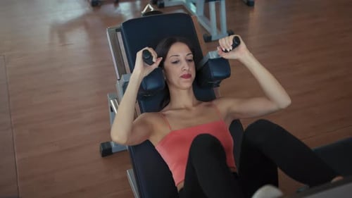 Woman Sliding On The Leg Press In The Gym