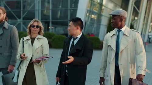 Stylish Business Team Walking and Talking Outdoors