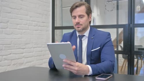 Man Uses Tablet in Bright Office Setting