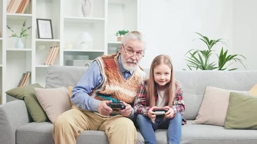 Grandfather and Granddaughter Play Video Games Together