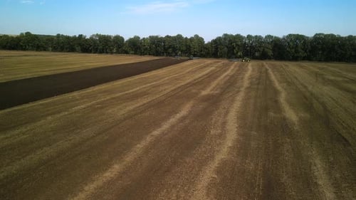 Tractors plowing the field in Ukraine